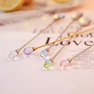 Long handled gold stirring spoons with colorful crystal diamond handles for cocktail and dessert.