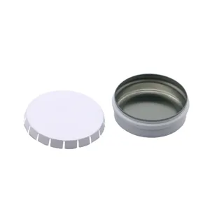 Close-up detail of a small round white metal tin box, empty storage container with separate lid.