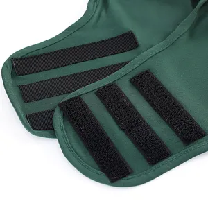 Detailed view of adjustable pet calming vest, soft green fabric with secure hook and loop closures.