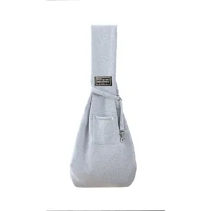 Grey fabric pet sling bag detail, comfortable pouch design for small cats and dogs outdoors.
