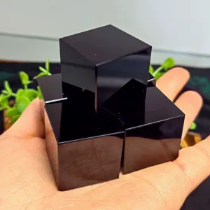 Natural polished black obsidian cube crystal stone for feng shui decor and paperweight.