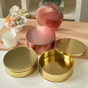 Round metal tin box for cookies, candy, and snacks storage. Elegant gold and rose gold finish.