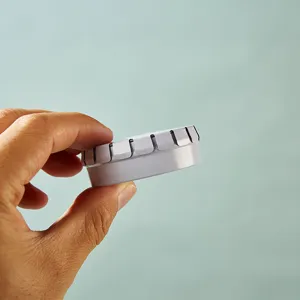 Closeup of small round metal tin box edge, perfect for lip balm, ointment or pill storage.