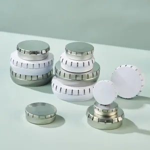 Round metal tin boxes for cosmetics, lip balm, mints and pills, set of various stackable sizes.
