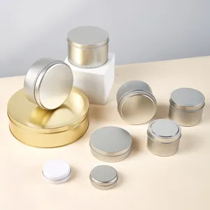 Detail shot of assorted round metal tin containers, multi-size silver and gold storage boxes.