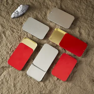 Close-up detail of portable sliding metal tin boxes, perfect for storing small items like pills or pins.