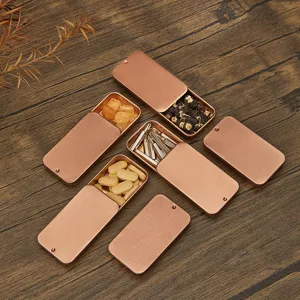 Boîte de rangement en métal coulissante or rose pour pilules, bonbons et petits accessoires.