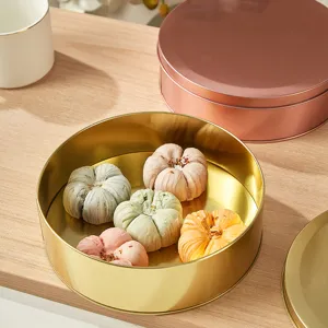 Round metal tinplate box for food, cookies, candies, and jewelry packaging in gold and rose gold.