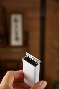Detailed close-up shot of the portable mini metal tin box featuring a convenient flip lid.