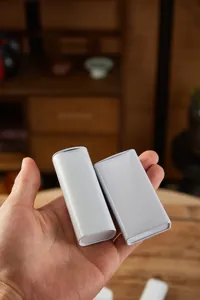 Detail shot of portable white metal tin boxes, blank minimalist pocket containers for mints.