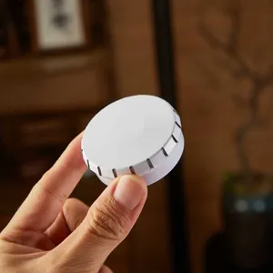 Mini white round tin box metal storage container for mints, candy, and small lip balm items.