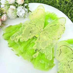 Green pet dress detail showcasing stunning tulle butterfly wings with sparkling sequins and lace.