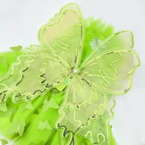 Detailed close-up of green pet fairy dress with sparkling sequin butterfly wings and mesh.
