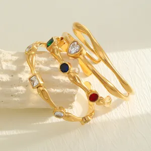 Close-up of 18K gold plated hammered bangles with colorful heart zircon details