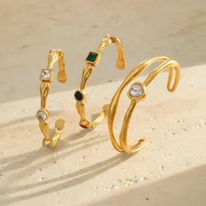 Detail of 18K gold plated stainless steel hammered bangles with colorful zircon stones.