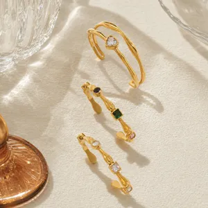 Detailed view of 18K gold plated hammered bracelets with heart and colorful zircons.