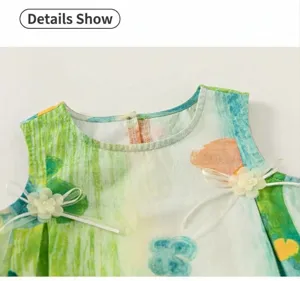 Kids cute graffiti sleeveless top detail shot featuring floral bow accents and green print.