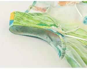 Detailed view of kids summer sleeveless dress with watercolor graffiti print and mesh tulle.