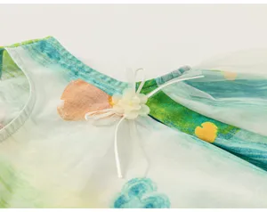 Children summer clothing detail shot, watercolor graffiti print, mesh sleeve and flower trim.