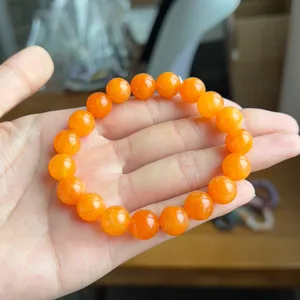 Stunning orange gemstone bead bracelet detail, elegant minimalist style stacking jewelry.