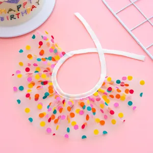 Detailed shot of colorful polka dot pet bib, sheer mesh fabric, cute birthday collar accessory.