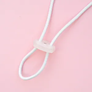 Close-up detail shot of elastic cord and plastic cord lock for adjustable accessories.