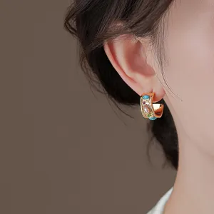 Close-up view of French vintage style gold hoop earrings with multi-color gemstone inlay.