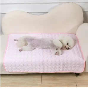 Pet cooling mat for dogs and cats, pink ice silk summer cooling pad detail view on sofa.