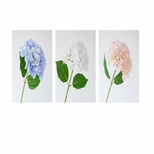 Detailed view of high-simulation artificial hydrangea flowers in blue, white, and champagne.