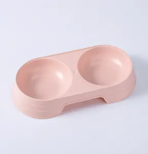 Pink plastic double pet bowl detail view, macaron color cat feeding basin, durable pet supplies.