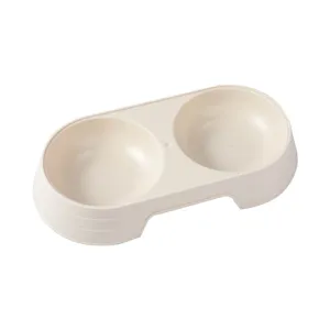 Double pet food bowl for cats and dogs, plastic feeding water basin in light beige color.