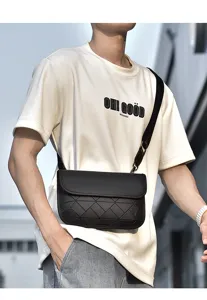 Detailed view of the black geometric crossbody bag, showcasing textured grid pattern and strap.