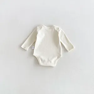 Infant baby long sleeve cotton bodysuit detail, plain light beige newborn baby romper.
