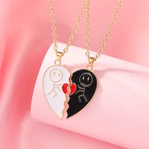 Detail view of the matching black and white heart pendant necklace with cute stick figures.