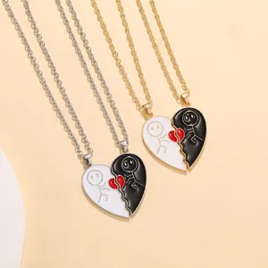 Detailed close-up of matching split heart necklaces with cute stick figures, ideal couple gift.