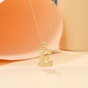 Close-up detail of the gold-plated letter E pendant necklace showcasing its fine texture.