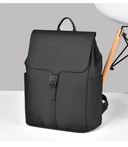 Detailed view of the black minimalist commuter backpack showing clean front flap and buckle.