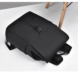 Detail view of black business casual backpack, featuring sleek flap and secure buckle.
