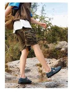 Outdoor view of men's breathable mesh beach sandals with hand-stitched detailing.