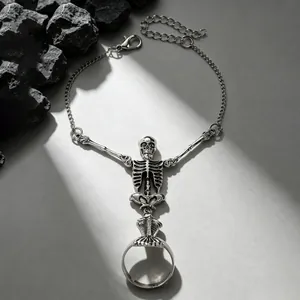 Detailed view of a gothic vintage silver skeleton hand chain bracelet with an attached ring.