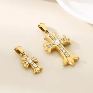 Stainless steel gold cross pendant detail shot, stylish jewelry accessory with sparkling crystal.