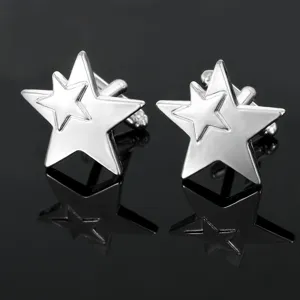 Close-up detail of silver-tone double star metal cufflinks for men's formal dress shirts.