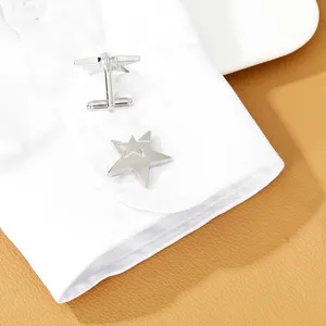 Silver layered star cufflinks detail shot, stylish metallic cuff link accessory for men.