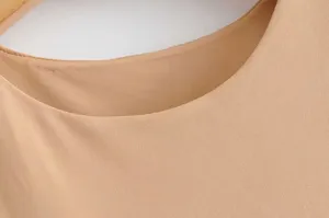 Close up detail view of solid round neck sleeveless bodysuit showing fine fabric texture.