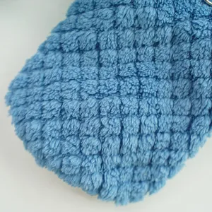 Close-up detail of blue plush fabric, thick textured fleece material for pet winter clothing.
