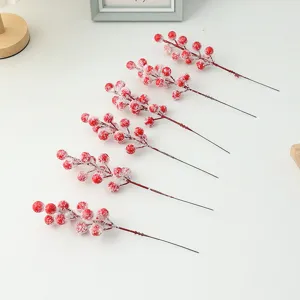 Close-up of frosted artificial red berry stems, perfect for DIY Christmas tree wreath decor.