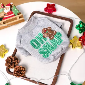 Close-up detail of grey pet Christmas sweater featuring cute gingerbread man and letter embroidery.