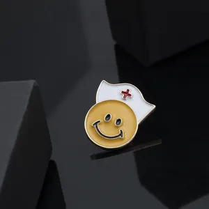 Detail close-up shot of the cute nurse smiley face brooch with alloy texture and red cross.