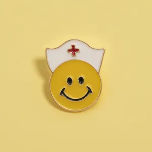 Close-up detail of cute nurse smiley face enamel pin, metal alloy badge for bags and jackets.