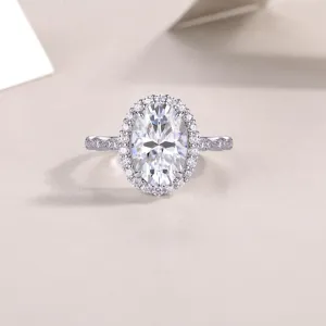 Detail view of the S925 silver oval moissanite ring with stunning halo and pave stone band.